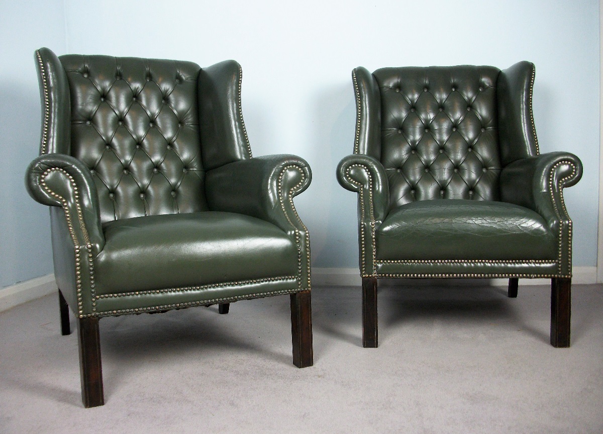 pair of green leather armchairs